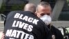 Un manifestante vestido con una camiseta con el lema 'Black Lives Matter' (Las vidas negras importan) abraza a un agente de la policía durante un protesta en la ciudad de Los Ángeles, el 2 de junio.