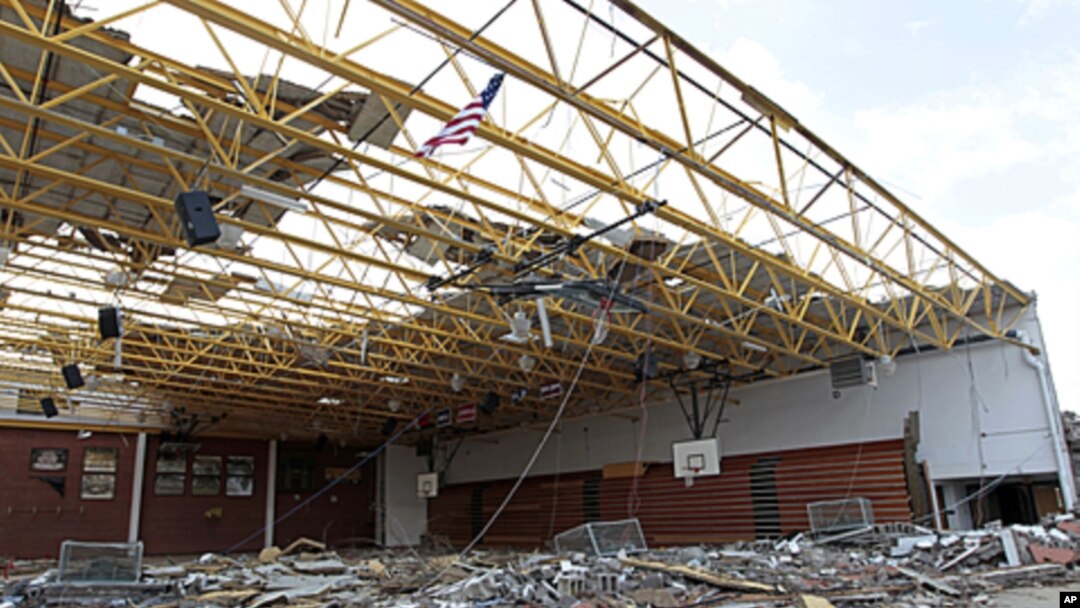An American flag flies over the damaged gym at Henryville High School in Henryville, Indiana, March 3, 2012.