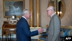 Britain's King Charles III (L) receives Peter Hillary, son of Sir Edmund Hillary, during an audience at Buckingham Palace, in London, on June 14, 2023, to mark the seventieth anniversary of the ascent of Mount Everest.