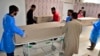 Hospital staff gather beside the bodies of persons who were killed by gunmen, at a hospital morgue in Quetta, Pakistan, on April 13, 2024.
