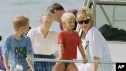 FILE - A photo of Princess Diana and sons Harry and William at Banana Bay Beach, St. Kitts, Jan. 4, 1993.