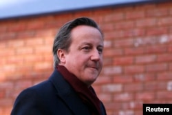 FILE - Britain's Prime Minister David Cameron arrives for his visit to the Harris City Academy in south London, Dec. 8, 2014.