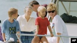 FILE - A photo of Princess Diana and sons Harry and William at Banana Bay Beach, St. Kitts, Jan. 4, 1993.