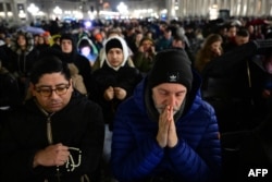 Umat menghadiri doa Rosario untuk kesehatan Paus Fransiskus yang dirawat di rumah sakit karena pneumonia, di Basilika Santo Petrus di Vatikan pada 24 Februari 2025. (Foto: AFP)