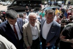 FILE - Mayor of Istanbul Ekrem Imamoglu, right, visits dismissed Diyarbakir Mayor Selcuk Mizrakli in Diyarbakir, Turkey, Aug. 31, 2019.