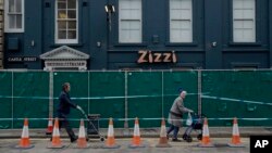 FILE - A police cordon and fence are placed outside a Zizzi restaurant near the area where former Russian double agent Sergei Skripal and his daughter were found critically ill following exposure to the Russian-developed nerve agent Novichok in Salisbury, England, March 13, 2018. 