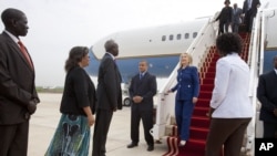 U.S. Ambassador of South Sudan Susan Page, second from left, and South Sudan Foreign Minister Nhial Deng Nhial, greet Secretary of State Hillary Rodham Clinton on her first visit to South Sudan, August 3, 2012, at Juba International Airport in Juba. 