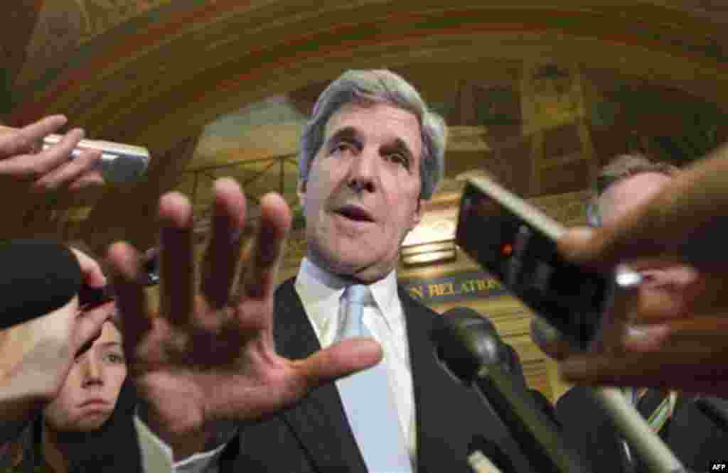 FILE - In this Nov. 17, 2011 file photo, Sen. John Kerry, D-Mass., and other Democratic members of the supercommittee, comment to reporters as they emerge from a closed-door meeting at the Capitol, in Washington. Fanning out to the sets of various talk sh