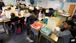 In this April 18, 2014 file photo, students are shown in a fourth-grade classroom at Olympic View Elementary School in Lacey, Washington. (AP Photo/Ted S. Warren)