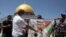 Palestinian protesters burn a banner showing Abu Dhabi Crown Prince Mohamed bin Zayed al-Nahyan during a protest against the United Arab Emirates' deal with Israel near the Dome of the Rock Mosque in the Al Aqsa Mosque compound in Jerusalem's old city.