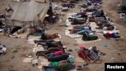 FILE - Ethiopian migrants sleep out in the open near a transit center where they wait to be repatriated, in the western Yemeni town of Haradh, on the border with Saudi Arabia. The U.N. refugee agency reports nearly 106,000 people, mostly from Ethiopia and Somalia, have risked their lives on the high seas to reach Yemen in 2016.