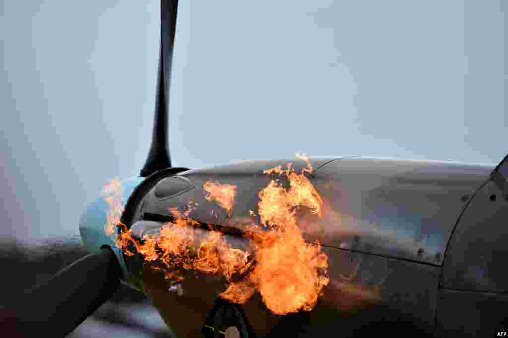 Flames are seen coming out of the exhaust pipes of a Hurricane aircraft as the engine is started before taking off from Biggin Hill airfield in Kent, Aug.18, 2015. World War II aircraft including 18 Spitfires and six Hurricanes flew over southeast England to mark the 75th anniversary of the &quot;hardest day&quot; of the Battle of Britain. &nbsp;