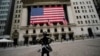 FILE - The Fearless Girl statue stands in front of the New York Stock Exchange in New York, April 5, 2020.