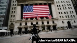 FILE - The Fearless Girl statue stands in front of the New York Stock Exchange in New York, April 5, 2020.