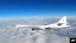 In this image made available by the Royal Air Force, Jan. 15, 2018, a Russian Tu-160 long-range bomber is photographed by an RAF aircraft.