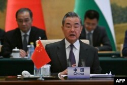 FILE —China's Foreign Minister Wang Yi attends a meeting with foreign ministers from Arab and Muslim-majority nations at the Diaoyutai State Guest House in Beijing on November 20, 2023.