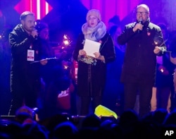 Gdansk Mayor Pawel Adamowicz, right, speaks to an audience at a charity event shortly before he was stabbed in Gdansk, Poland, Jan. 13, 2019.