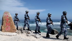 Soldiers of China's People's Liberation Army Navy patrol at Woody Island, in the Paracel Archipelago