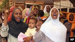 People shout during a an Islamic Liberation Party rally to support the Sudanese Armed Forces and condemn the intervention of international peacekeepers in Abyei in Khartoum on June 11, 2011.