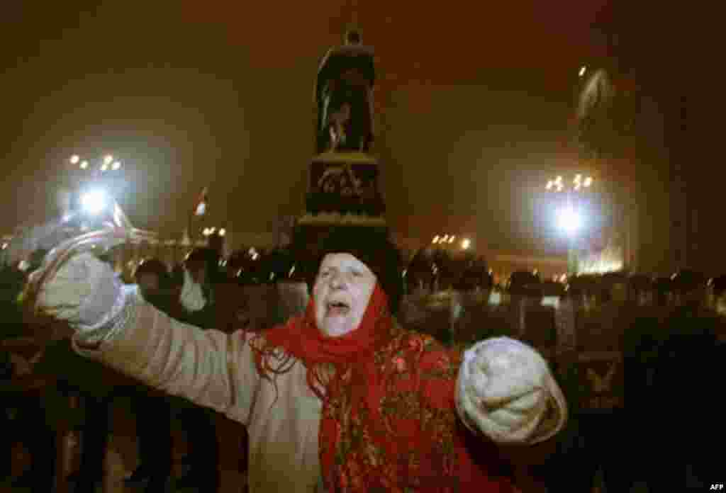 A woman shouts slogans in front of riot police during a rally in Minsk, Berlarus, Monday, Dec. 20, 2010. Thousands of opposition supporters in Belarus tried to storm the main government building to protest what the opposition claims was large-scale vote-r