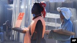 FILE - Vendors sells sweets and mobile phone recharge cards in central Harare.