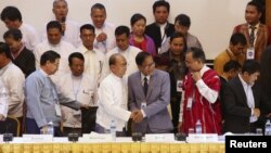 缅甸总统吴登盛(左三)和缅甸全国停火协调小组（NCCT）的领导人乃汉达（右三）在仰光签订全国性的停火协议草案后握手。（资料照片）