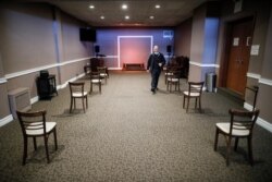 Pat Marmo, owner of Daniel J. Schaefer Funeral Home, walks through a viewing room set up to respect social distancing April 2, 2020, in the Brooklyn borough of New York.