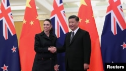 中国国家主席习近平2019年4月1日在北京人大会堂与到访的新西兰总理阿德恩握手。（路透社）