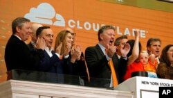 FILE - Cloudflare co-founder and CEO Matthew Prince, right center, applauds during New York Stock Exchange opening bell ceremonies to celebrate his company's IPO, Sept. 13, 2019.