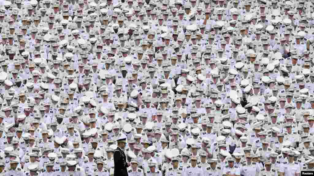 Underclassmen listen from the back of the stadium as U.S. President Barack Obama speaks at a commencement ceremony at the United States Military Academy at West Point, New York.