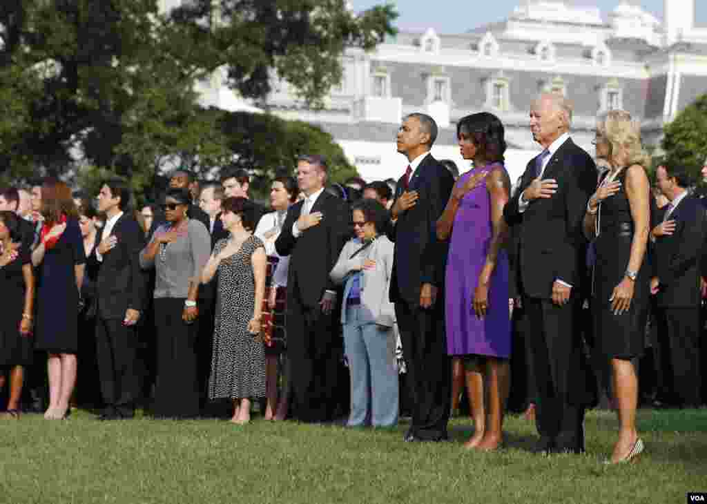 U.S. President Barack Obama, first lady Michelle Obama, Vice President Joe Biden and Jill Biden pause for a moment of silence on the 12th anniversary of the September 11 attacks on the South Lawn of the White House.