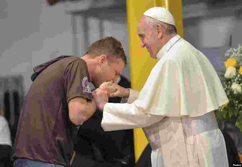 A patient kisses the hand of Pope Francis at the Hospital Sao Francisco in Rio de Janeiro, July 24, 2013. 