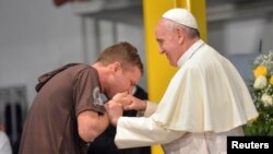 一名病人在里約熱內盧的一家醫院吻教宗的手