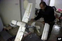 FILE - An Iraqi officer inspects drones belonging to Islamic State militants in Mosul, Iraq, Jan. 27, 2017.