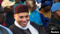 Karim Wade (C), son of Senegal's former president Abdoulaye Wade, attends a rally by his father's political party Parti Democratique Senegalais (PDS) in Dakar, Dec. 6, 2012. 
