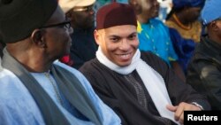 Karim Wade (R), son of Senegal's former president Abdoulaye Wade, attends a rally by his father's political party Parti Democratique Senegalais (PDS) in Dakar, Dec. 6, 2012. 