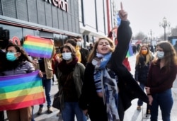FILE - Students walk with rainbow flags during a gathering in solidarity with Bogazici University students protesting the appointment of Melih Bulu as rector of the university, in Ankara, Turkey, Feb. 2, 2021.