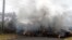 Lava crosses the road near Pohoiki Road, May 18, 2018, near Pahoa, Hawaii. Several open fissure vents are still producing lava splatter and flow in evacuated areas. Gas is also pouring from the vents, cloaking homes and trees in smoke. 