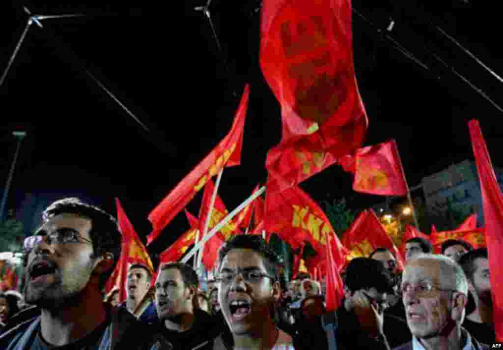 Suporters of Greece's Communist party chant slogans and wave flags during a rally in central Athens, on Monday, Nov. 15, 2010. More than 6,000 students and left-wing protesters took part in two separate demonstrations in central Athens Monday evening, 