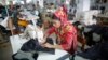 FILE - A worker is seen sewing jeans in a garment factory in Savar, Bangladesh.