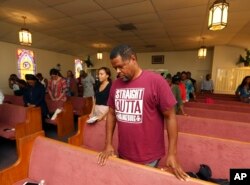 A man prays during Black Voters Matter's The South Is Rising Tour 2018 on Aug. 22, 2018, in Warner Robins, Ga.