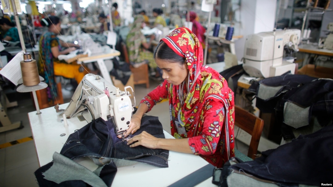 FILE - A worker is seen sewing jeans in a garment factory in Savar, Bangladesh.