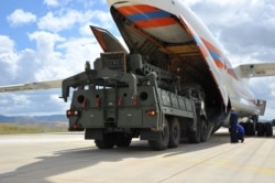 FILE - The first parts of a Russian S-400 missile defense system are unloaded from a Russian plane near Ankara, Turkey, July 12, 2019.