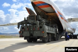 FILE - The first parts of a Russian S-400 missile defense system are unloaded from a Russian plane near Ankara, Turkey, July 12, 2019.