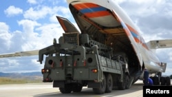 FILE - Parts of a Russian S-400 missile defense system are unloaded from a Russian transport plane near Ankara, Turkey, July 12, 2019.