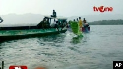 People remove debris of a plane, that had crashed into the sea off Papua province, from the water in this still image taken from video, May 7, 2011