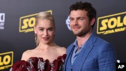 Emilia Clarke and Alden Ehrenreich arrive at the premiere of "Solo: A Star Wars Story" at El Capitan Theatre, May 10, 2018, in Los Angeles. 