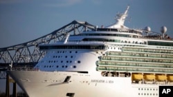 FILE - A Royal Caribbean cruise line pulls out of New Orleans on the Mississippi River, Feb. 2, 2013.