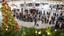 Travelers form lines outside the TSA security checkpoint during the holiday season as the new coronavirus omicron variant threatens to increase COVID case numbers, at Hartsfield-Jackson Atlanta International Airport in Atlanta, Ga., Dec. 22, 2021.