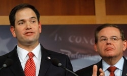 Senators Robert Menendez (D-NJ), right, and Marco Rubio (R-Fla) attend a news conference on comprehensive immigration reform at the U.S. Capitol in Washington January 28, 2013.